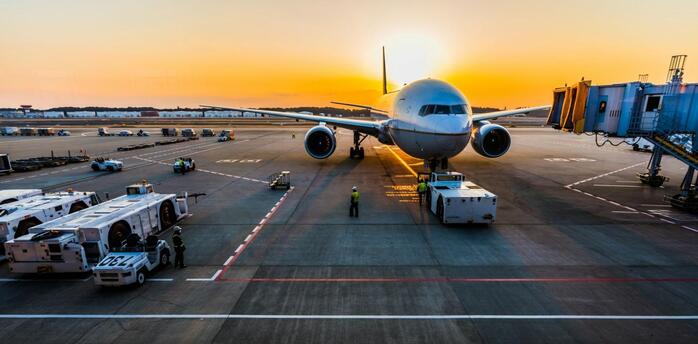 Aircraft being prepared for departure at sunrise