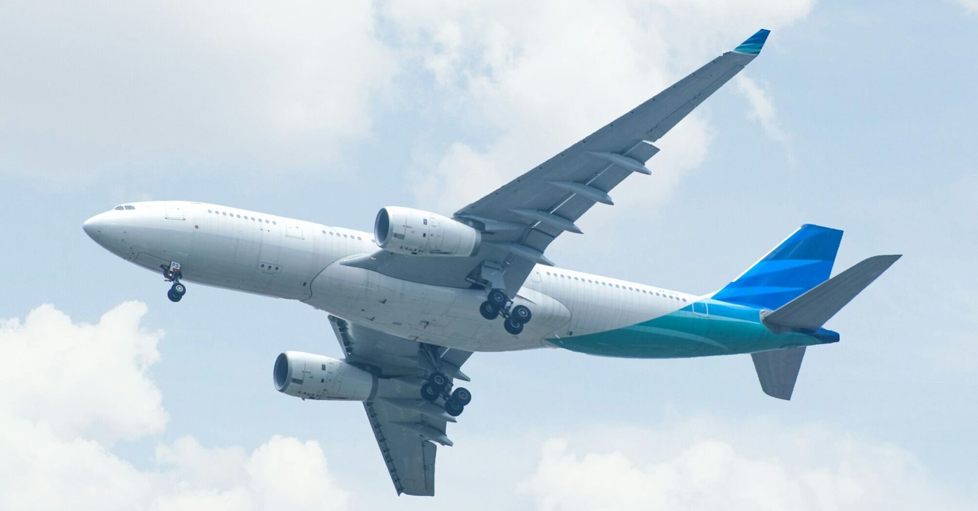 Commercial airplane taking off under a bright sky