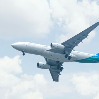 Commercial airplane taking off under a bright sky