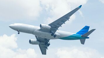 Commercial airplane taking off under a bright sky
