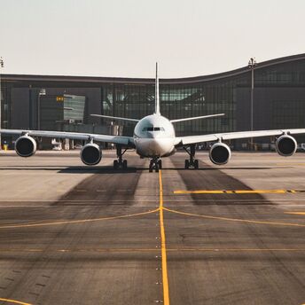 Airplane preparing for departure at a modern UK airport terminal