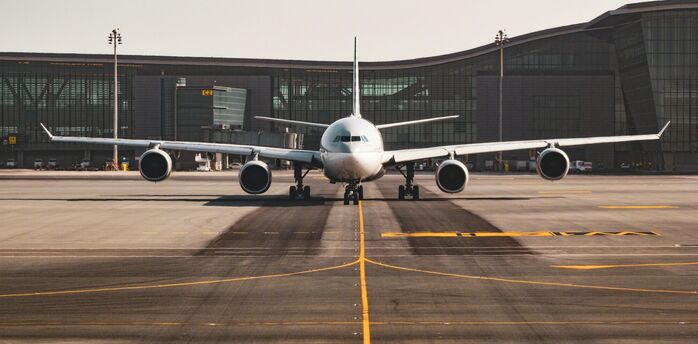 Airplane preparing for departure at a modern UK airport terminal