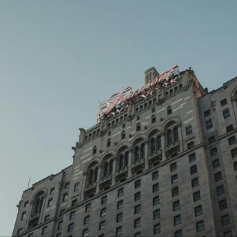 The historic façade of a Fairmont hotel under a clear sky