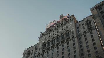 The historic façade of a Fairmont hotel under a clear sky