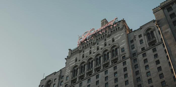 The historic façade of a Fairmont hotel under a clear sky