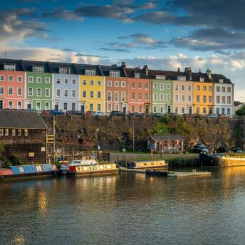 Colourful houses along Bristol Harbourside reflecting in evening light