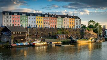 Colourful houses along Bristol Harbourside reflecting in evening light