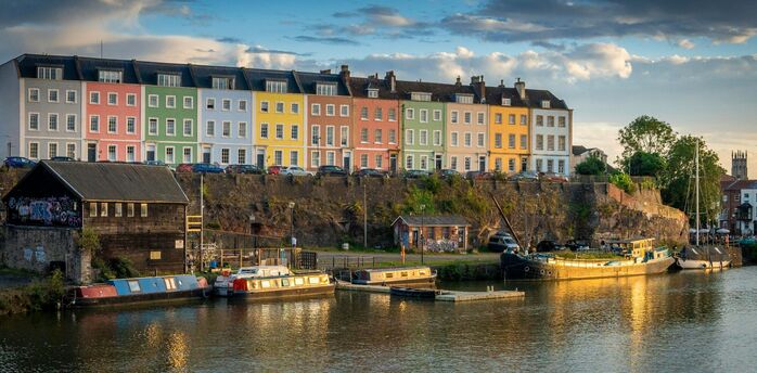 Colourful houses along Bristol Harbourside reflecting in evening light