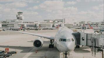 Airplane preparing for departure at a busy international airport terminal
