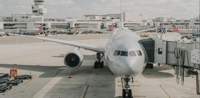 Airplane preparing for departure at a busy international airport terminal