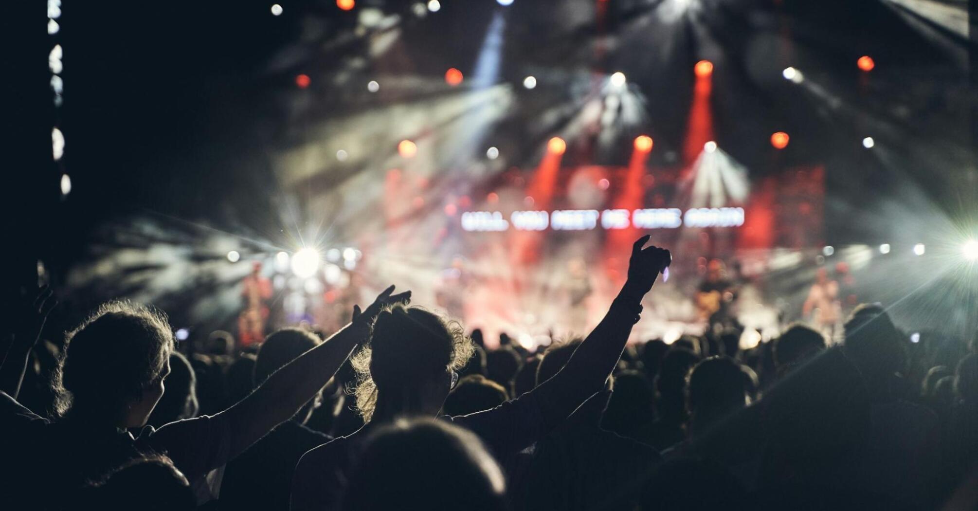 Crowd enjoying a live concert under stage lights in Edinburgh