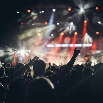 Crowd enjoying a live concert under stage lights in Edinburgh