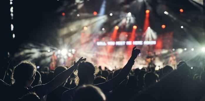Crowd enjoying a live concert under stage lights in Edinburgh