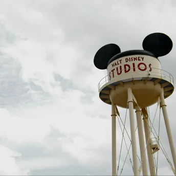 Walt Disney Studios water tower with Mickey Mouse ears under cloudy sky