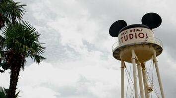Walt Disney Studios water tower with Mickey Mouse ears under cloudy sky