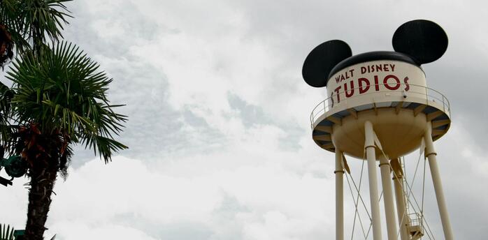 Walt Disney Studios water tower with Mickey Mouse ears under cloudy sky
