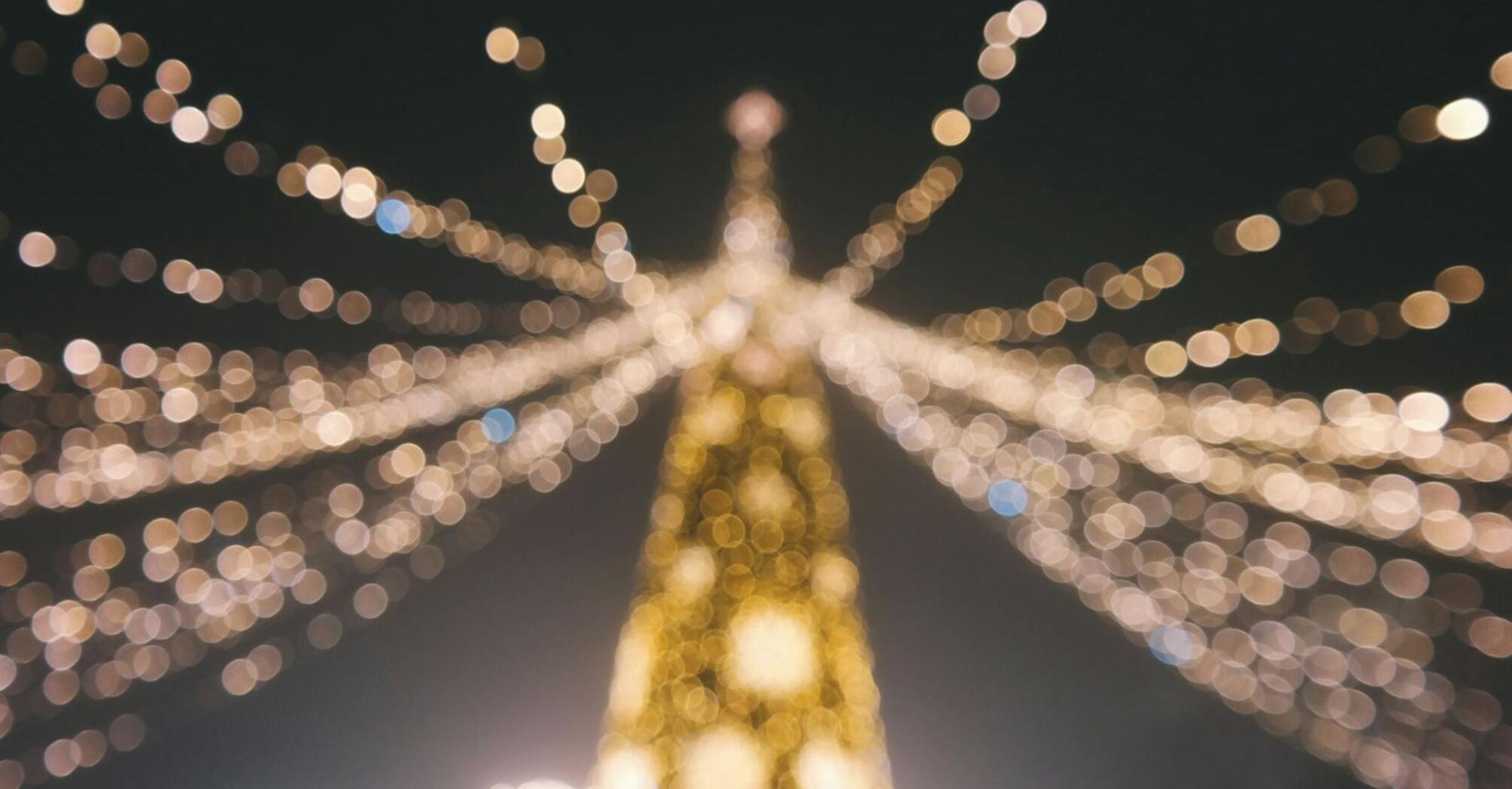 Blurred view of Christmas lights forming a festive tree shape