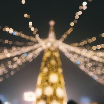 Blurred view of Christmas lights forming a festive tree shape
