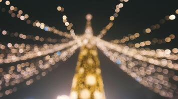 Blurred view of Christmas lights forming a festive tree shape