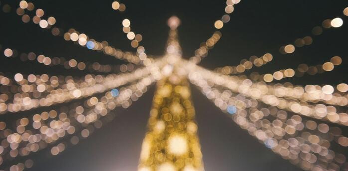 Blurred view of Christmas lights forming a festive tree shape