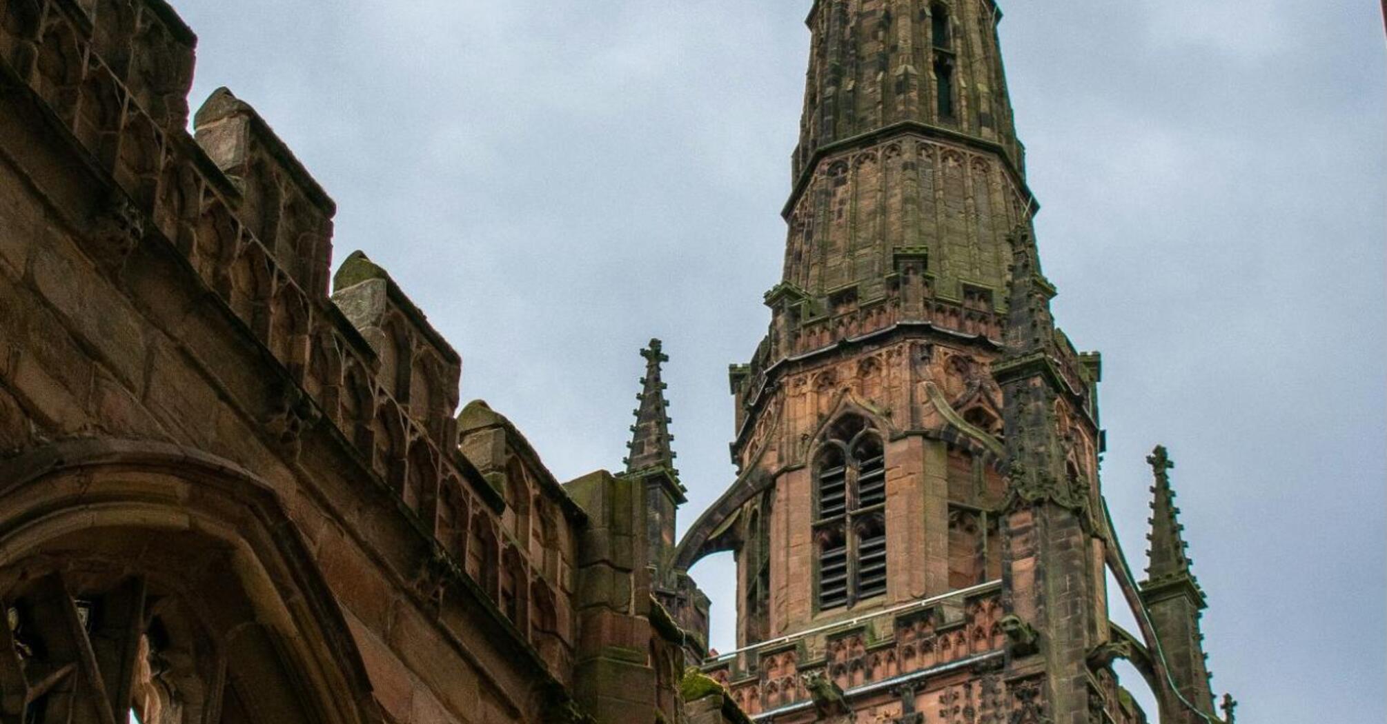 Coventry Cathedral spire standing above the ruins of the old church after wartime destruction