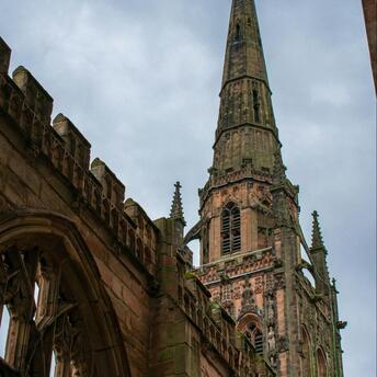 Coventry Cathedral spire standing above the ruins of the old church after wartime destruction