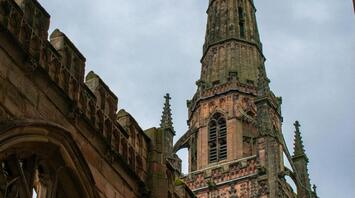 Coventry Cathedral spire standing above the ruins of the old church after wartime destruction