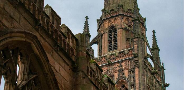 Coventry Cathedral spire standing above the ruins of the old church after wartime destruction
