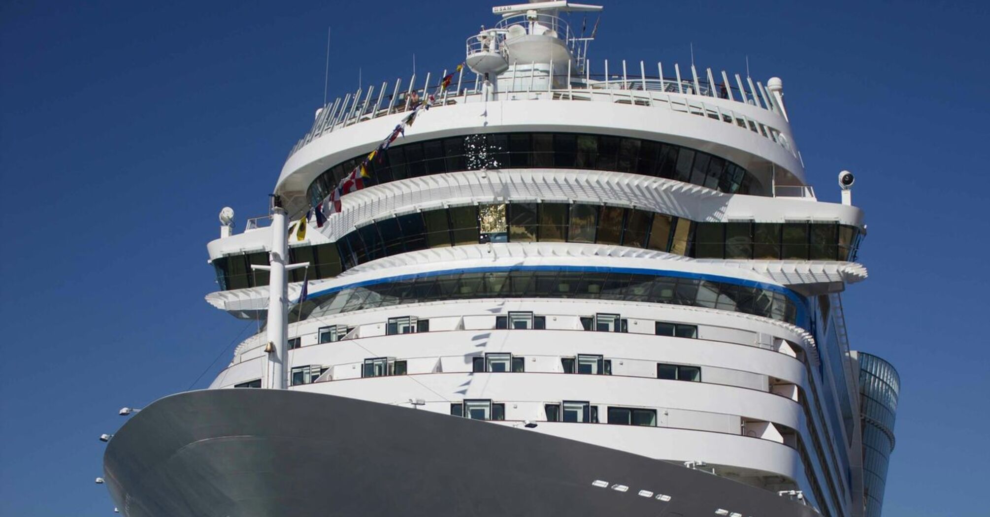 Luxury cruise ship docked under clear blue sky