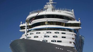 Luxury cruise ship docked under clear blue sky