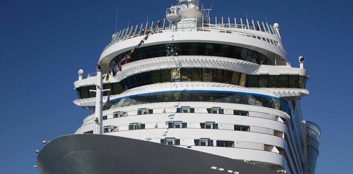 Luxury cruise ship docked under clear blue sky