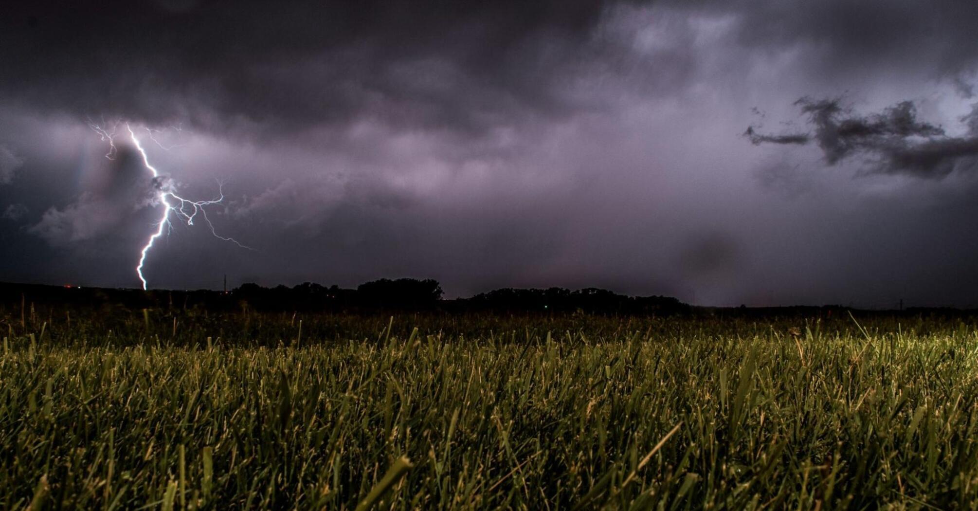 Lightning storm over a grassy field during severe weather in Germany