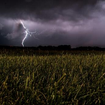 Lightning storm over a grassy field during severe weather in Germany