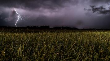 Lightning storm over a grassy field during severe weather in Germany