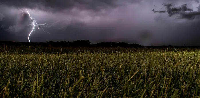Lightning storm over a grassy field during severe weather in Germany