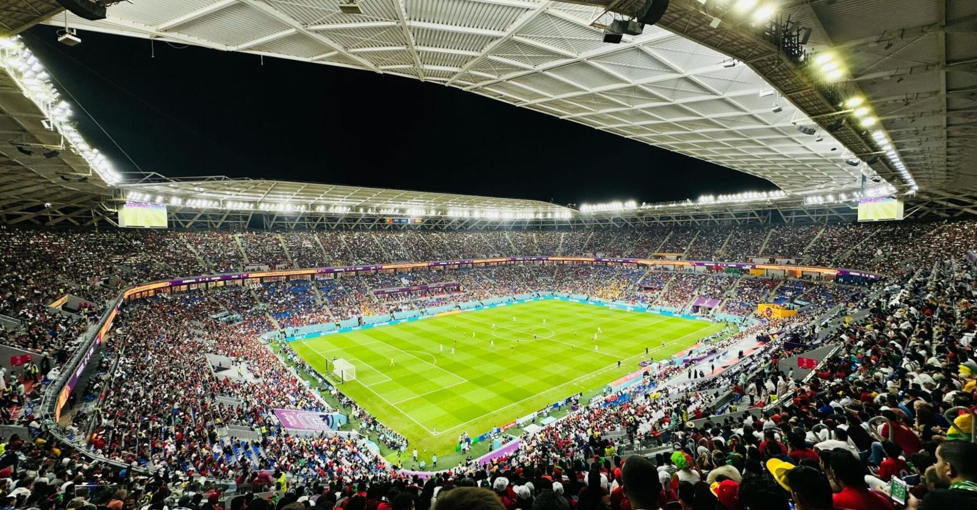 Crowded football stadium in Doha during a night match at one of Qatar’s major venues