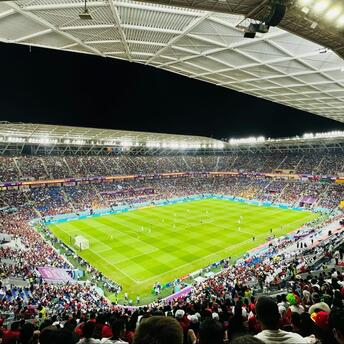 Crowded football stadium in Doha during a night match at one of Qatar’s major venues