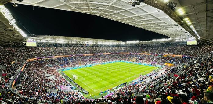 Crowded football stadium in Doha during a night match at one of Qatar’s major venues