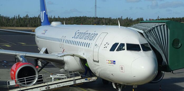SAS aircraft boarding at a Scandinavian airport terminal