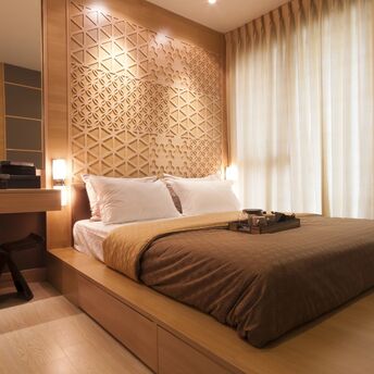 Modern hotel room with warm wooden design and natural light