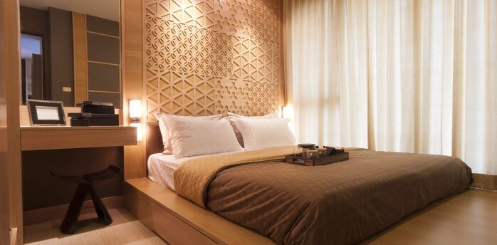 Modern hotel room with warm wooden design and natural light