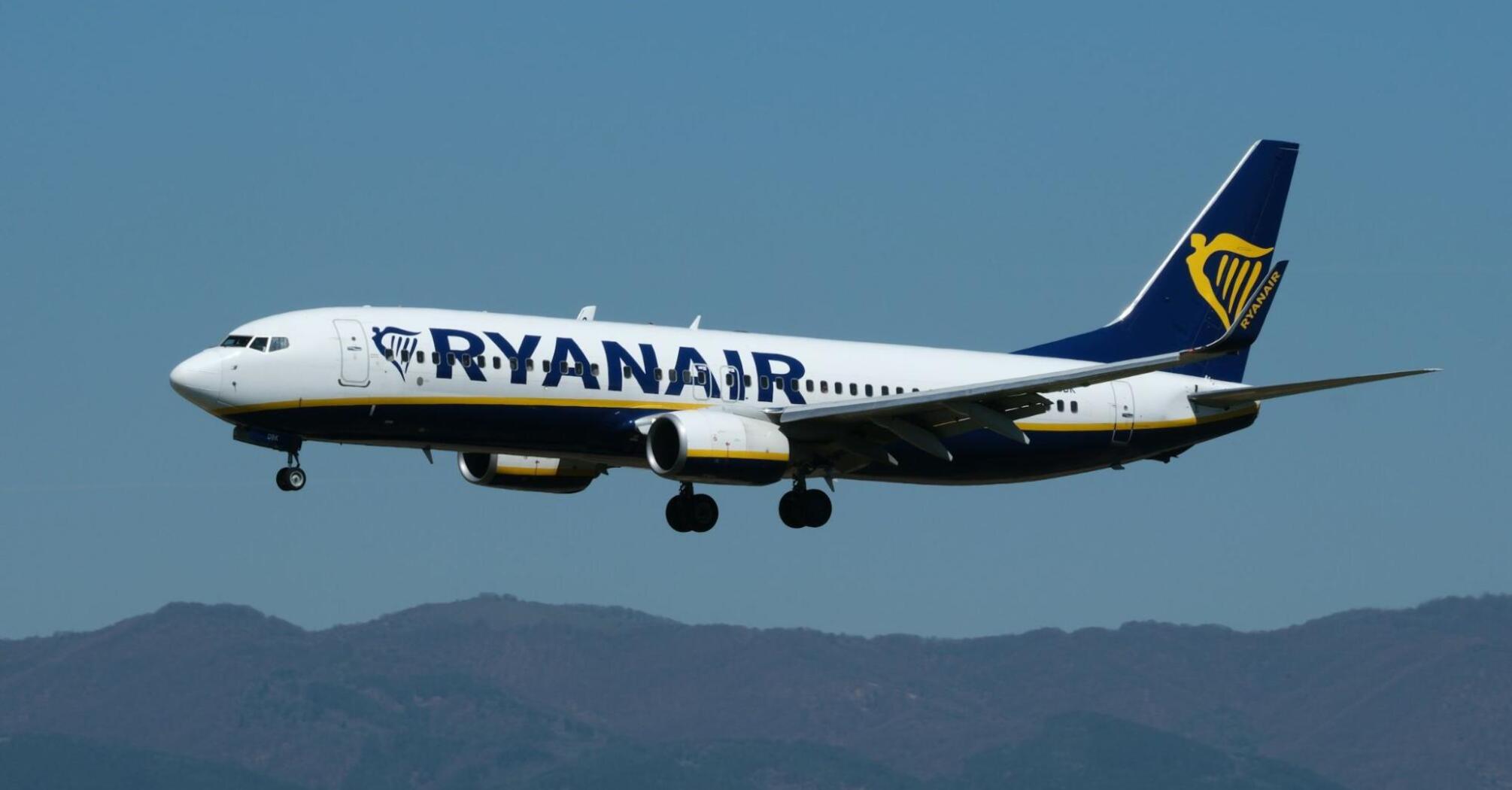 Ryanair aircraft approaching for landing against clear sky