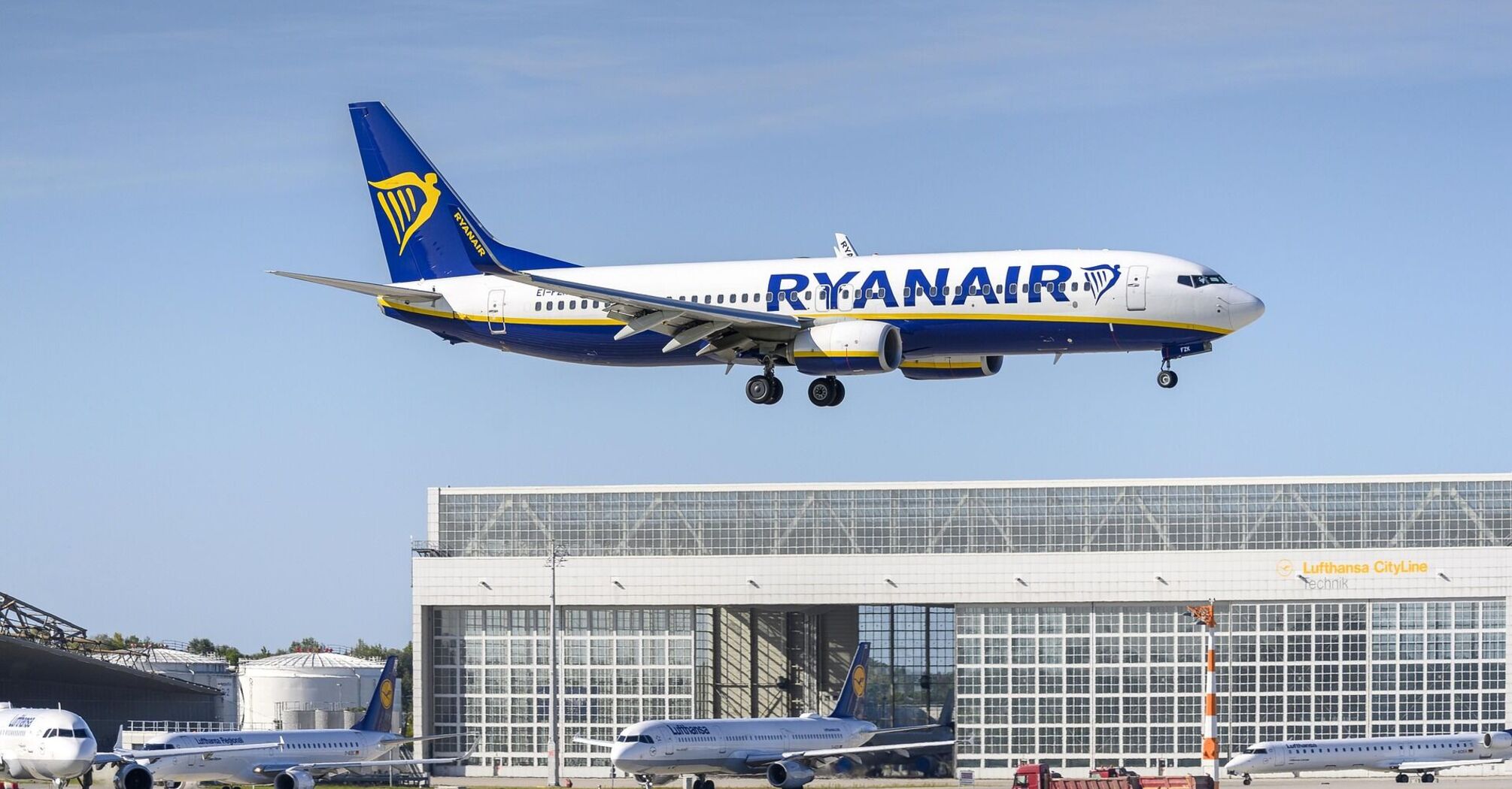 Ryanair aircraft approaching an airport runway on a clear day