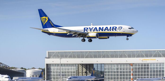 Ryanair aircraft approaching an airport runway on a clear day