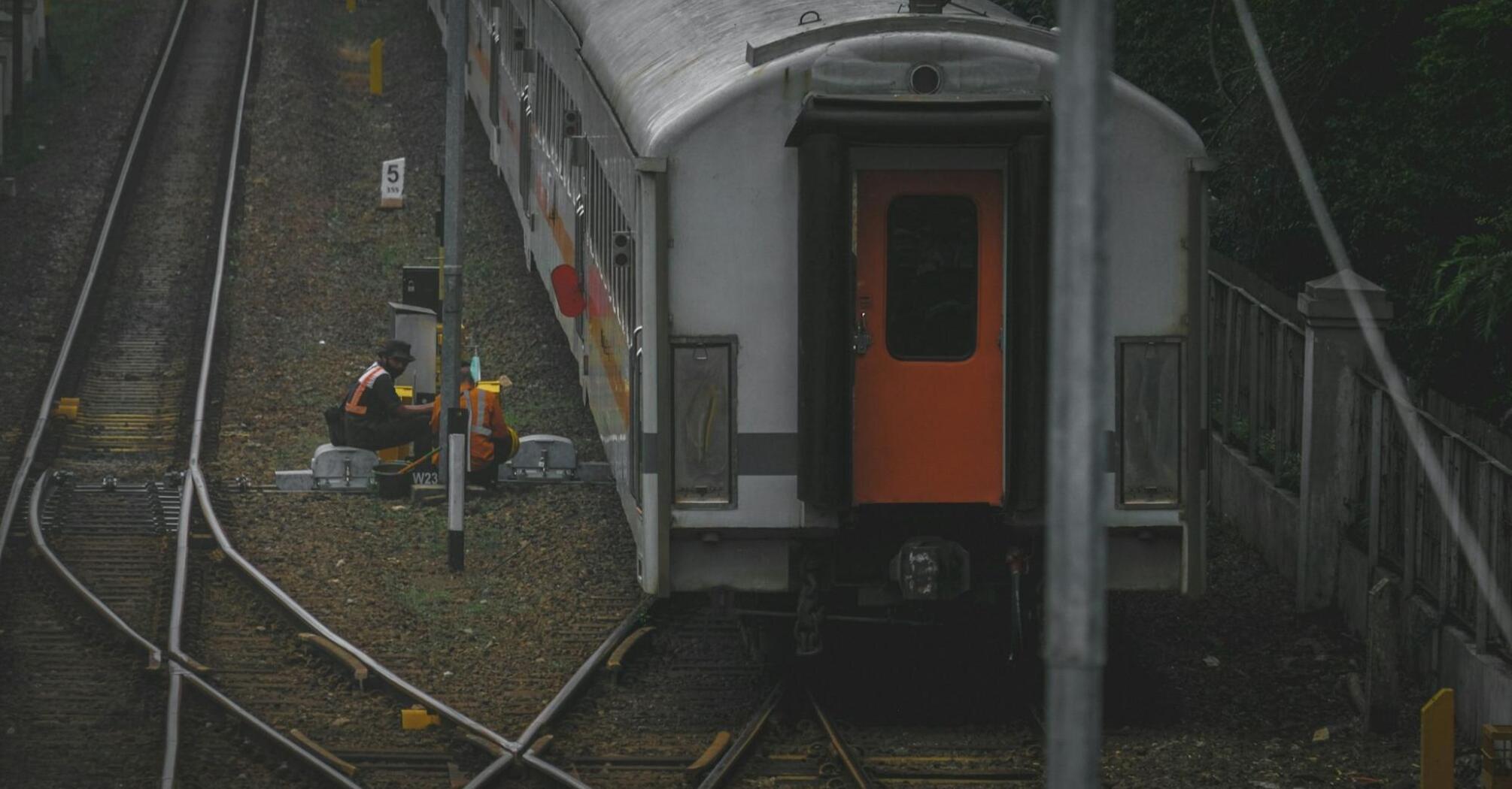 Railway workers conducting maintenance on train tracks in Rome