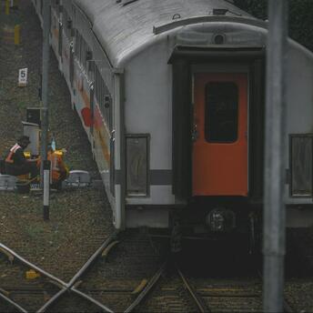 Railway workers conducting maintenance on train tracks in Rome