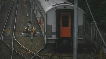 Railway workers conducting maintenance on train tracks in Rome