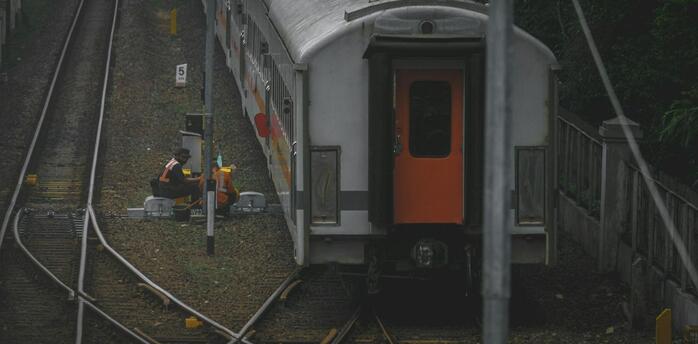 Railway workers conducting maintenance on train tracks in Rome