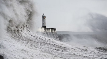 Lighthouse battered by massive storm waves