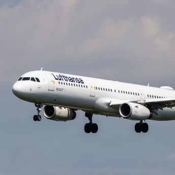 A Lufthansa airplane in flight against a cloudy sky